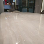 Cream White High-Gloss Dining Table with Rounded Corners and Architectural Gold Metal Bas